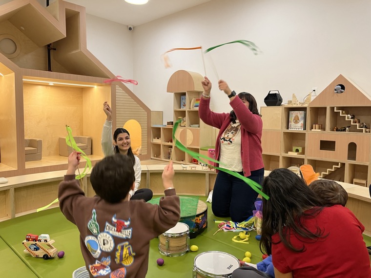 Educators and children at a music-and-movement circle at Boogles Playhouse